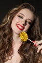 Pretty girl eats sweet candy lollipop candy Royalty Free Stock Photo