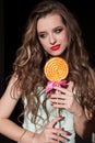 Pretty girl eats sweet candy lollipop candy Royalty Free Stock Photo