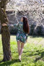 Pretty girl in fantasy dress full lengh back in a garden Royalty Free Stock Photo