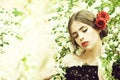 Pretty girl with fashionable spanish makeup, rose flower in hair Royalty Free Stock Photo