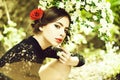 Pretty girl with fashionable spanish makeup, rose flower in hair Royalty Free Stock Photo