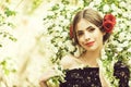 Pretty girl with fashionable spanish makeup, rose flower in hair Royalty Free Stock Photo