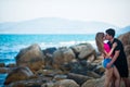 Pretty girl and guy kissing on the background of the sea Royalty Free Stock Photo
