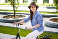 Pretty girl in hat riding a bicycle at street Royalty Free Stock Photo