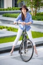 Pretty girl in hat riding a bicycle at street Royalty Free Stock Photo