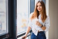 Pretty girl having coffee by the window Royalty Free Stock Photo