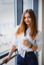 Pretty girl having coffee by the window Royalty Free Stock Photo