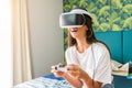 Pretty girl having fun playing videogames with virtual reality device.