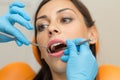 Pretty girl having mouth checkup in hospital by professional female dentist