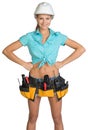 Pretty girl in helmet, shorts, shirt and tool belt Royalty Free Stock Photo
