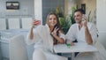 Pretty girl and her loving boyfriend are taking selfie with cocktail glasses using smartphone while relaxing in spa Royalty Free Stock Photo