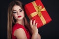 Pretty girl is holding gift box, Christmas time Royalty Free Stock Photo