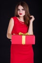 Pretty girl is holding gift box, Christmas time Royalty Free Stock Photo