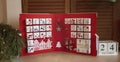 Pretty girl holds original advent calendar made of jewelry boxes and binder, Christmas diy craft