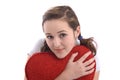 Pretty girl hugging a big red plush heart Royalty Free Stock Photo