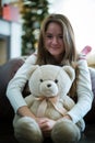 Pretty girl hugs teddy bear. Christmas time. Royalty Free Stock Photo