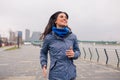 Pretty girl jogging on the river bank. Cloudy rain day Royalty Free Stock Photo