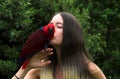 Pretty Girl Kissing A Parrot Royalty Free Stock Photo