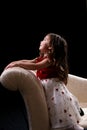 Pretty girl kneeling on couch and looking up