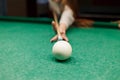 Close up at the girl aiming a cue ball on a ball in a pool table Royalty Free Stock Photo