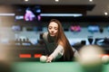 Cute girl plays billiards in a bar Royalty Free Stock Photo