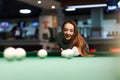 Gambling woman plays snooker in a billiards club Royalty Free Stock Photo