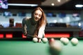 Gambling woman plays snooker in a billiards club Royalty Free Stock Photo