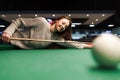 Smiling girl plays billiards in the club Royalty Free Stock Photo