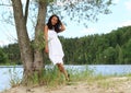 Pretty girl leaning on tree by Dam Rimov Royalty Free Stock Photo