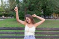 Pretty girl is listening to music in headphones outside. Favourite song. Woman is having rest in the park Royalty Free Stock Photo