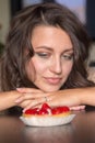 Pretty girl Looking to strawberry cake Royalty Free Stock Photo