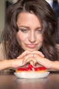 Pretty girl Looking to strawberry cake Royalty Free Stock Photo