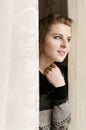Pretty Woman peeping from behind the curtain Royalty Free Stock Photo