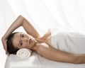 Pretty girl lying on a table with towel and hand o Royalty Free Stock Photo