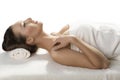 Pretty girl lying on a table with towel in profile Royalty Free Stock Photo