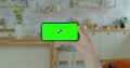 Pretty girl making video call on smartphone. Woman at Home Uses Green Mock-up Screen Smartphone. Watching Video Content Royalty Free Stock Photo
