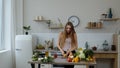 Pretty girl near table with juicy apple. Cutting with knife. Healthy nutrition vegetarian eco food Royalty Free Stock Photo