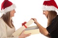 Pretty girl opening Xmas present from her friend Royalty Free Stock Photo