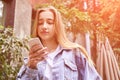 Pretty girl outdoors. Caucasian real people using mobile phone Royalty Free Stock Photo