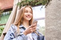 Pretty girl outdoors. Caucasian real people using mobile phone Royalty Free Stock Photo