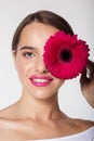 Pretty girl with perfect skin holding gerbera flower Royalty Free Stock Photo