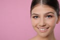 Pretty girl on pink background, space for text. Beautiful face with perfect smooth skin Royalty Free Stock Photo