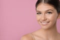 Pretty girl on pink background, space for text. Beautiful face with perfect smooth skin Royalty Free Stock Photo