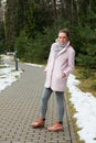 Girl in pink coat walking along pathway in forest Royalty Free Stock Photo