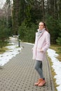 Girl in pink coat walking along pathway in forest Royalty Free Stock Photo