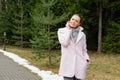 Girl in pink coat walking along pathway in forest Royalty Free Stock Photo