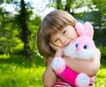 Pretty girl with pink soft rabbit