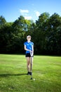 Pretty girl playing golf on field Royalty Free Stock Photo