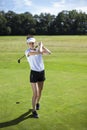 Pretty girl playing golf on grass Royalty Free Stock Photo