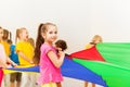 Pretty girl playing parachute with her friends Royalty Free Stock Photo